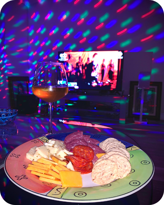 At-home music festival setup with livestream, speakers, snacks, and colorful lighting
